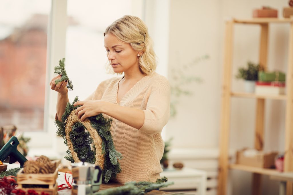 Young woman preparing decorations for Christmas